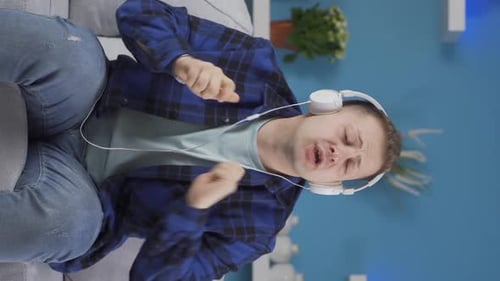 Enthusiastic Young Adult Listening to Music at Home