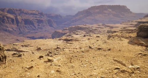 Desert Scene Features Rugged Terrain and Mountains in Bright Sunlight