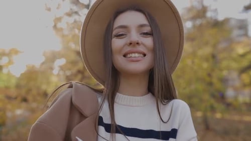 Closeup of a Beautiful Drunepka in a Brown Hat Walking Outdoors in the Park Posing for the Camera