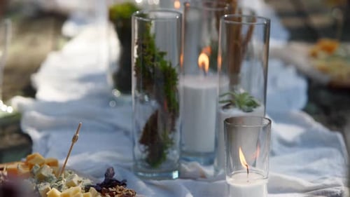 Table Set with Food and Candles in the Woods