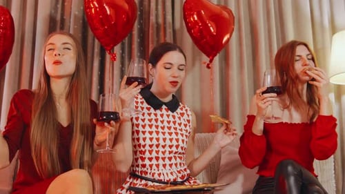 Three Women Celebrate with Pizza and Wine