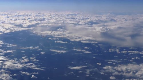Time lapse flight above a sea of fluffy clouds toward a sunrise horizon