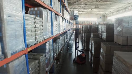 Aerial Drone Shot of Working Forklift Loader inside Logistic Warehouse