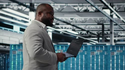 Cheerful Data Center System Administrator Reviews Code for Automation Scripts