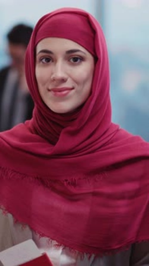 Smiling Woman Wearing a Red Headscarf Indoors