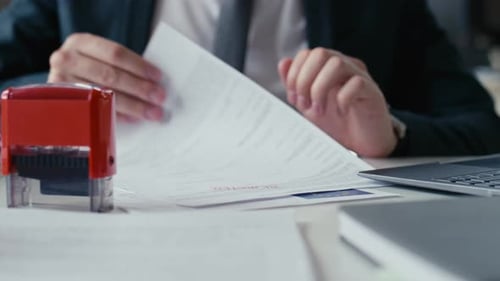 Document Rejected by Man Stamping Paperwork