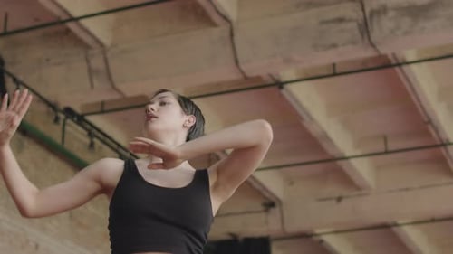 Woman Dancing Expressively in Industrial Space
