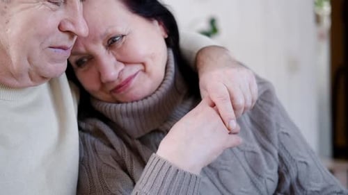 Affectionate Senior Couple Holding Hands and Embracing