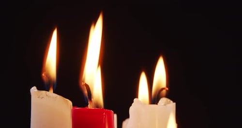Burning Candles Illuminating Dark Background