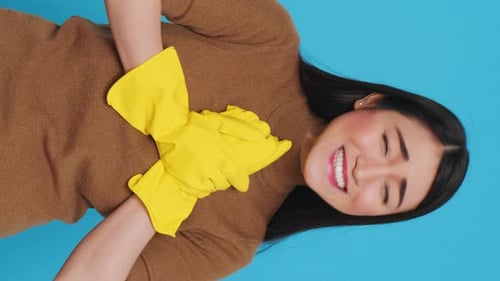 Woman with Yellow Gloves Laughing and Hugging Herself