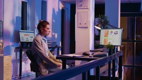 Business Woman Working Late at Computer in Office