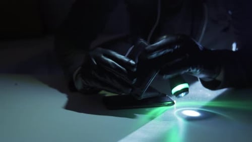 Figure Stealing Cash and Phone at Night