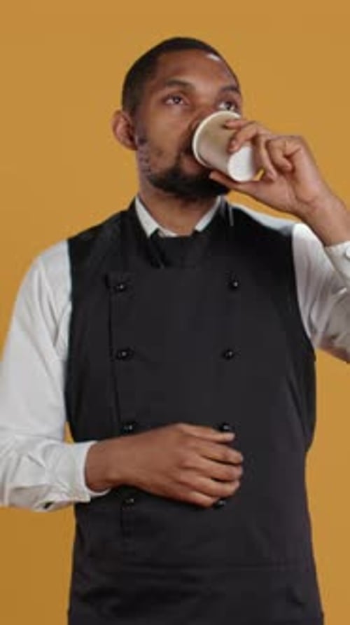 Vertical Video Restaurant Waiter Enjoying a Cup of Coffee Drink on His Work Break