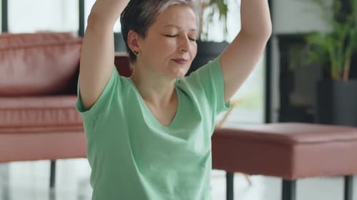 Woman Practices Yoga in her Modern Living Room