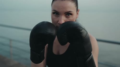 Woman With Boxing Gloves Posing For Camera