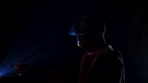 Man Wearing VR Headset and Holding Controller