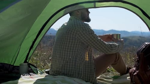 Hiker Tourist Traveler Man Drinking Hot Thermos Cup Mountain Camping Camp Tent Traveling Hikingю