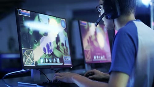 Young Man Playing Video Game on Computer at Night