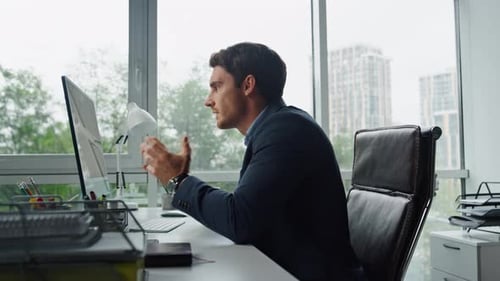 Professional Man Talking on Computer Video Call in Office