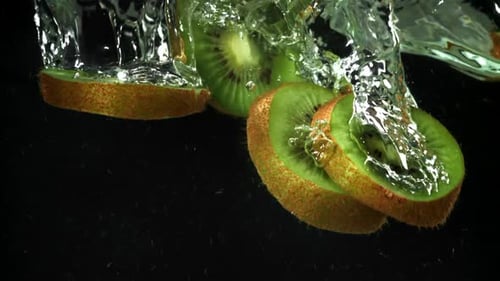 Vibrant Sliced Kiwi Fruit Falling into Water