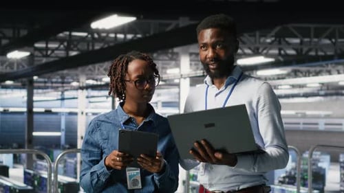 Data Center Admins Running Diagnostics on Equipment Doing Brainstorming