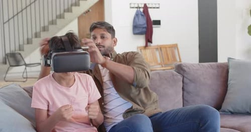 Father Puts VR Headset on Son's Head