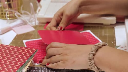 Woman Crafts a Handmade Card at Table