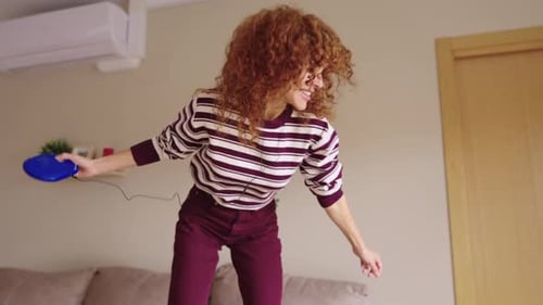 Energetic Redhead Woman Dancing with Retro Cd Player
