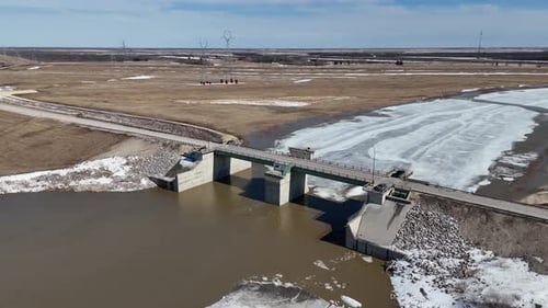 Red River Floodway Gates Winnipeg Manitoba Canada Aerial Drone Orbit Left Descend Spring Breakup