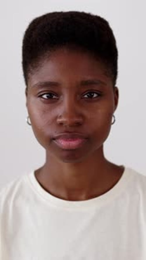 Portrait of Young Confident Black Woman Looking at Camera Sitting at Workplace