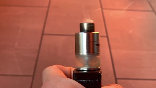 Close Up of a Vaping Device Emitting Smoke