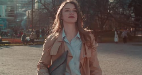 Back Lit Shot of Beautiful Young Confident Caucasian Businesswoman with Laptop Walk to Camera in