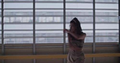 Young Woman Dancing Energetically Indoors