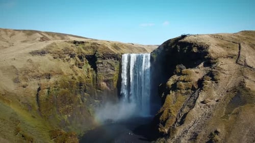 Epic Drone Shot Of Powerful Waterfall In Iceland, Water Rushing Down Tall Cliff