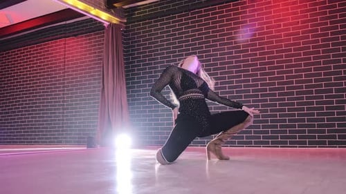Blonde Woman Dancing in an Urban Dance Studio