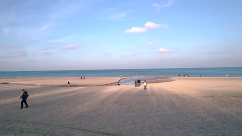 Menschen, die an einem sonnigen Wintertag an einem Ostseestrand in Danzig spazieren gehen