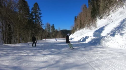 Woman Riding Snowboard in the Mountains Freeride Snowboarder Girl in Sports Equipment Riding Snow