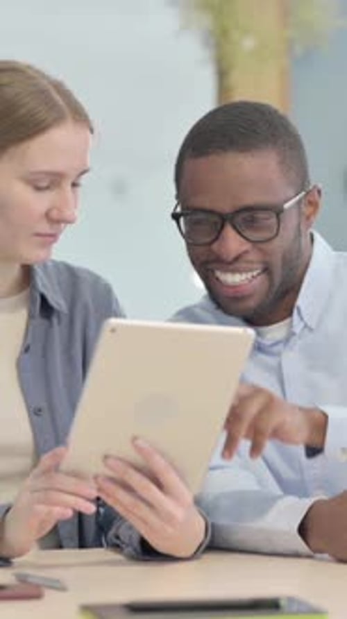 Young Adults Discussing Content on Tablet Device