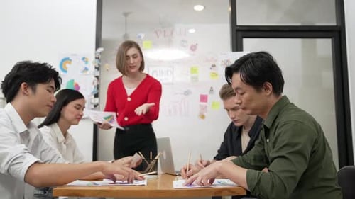 Business Team Meeting to Discuss a Project in Office