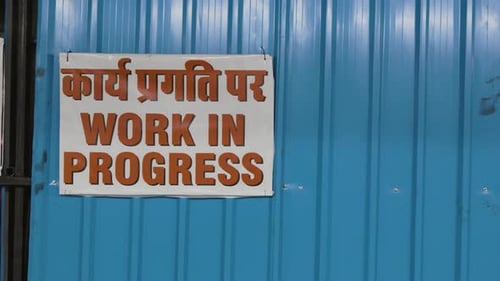 work in progress signboard at construction site at evening