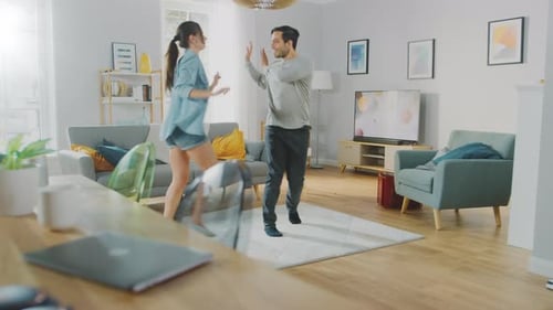Couple Dancing and Having Fun in Living Room