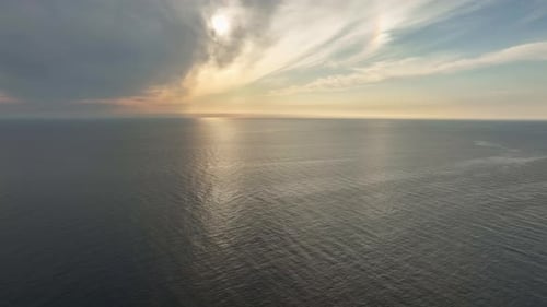 Seascape with Setting Sun - Sunset Behind Clouds Over the Ocean AERIAL