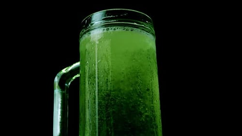 Green Beer with Foam and Bubbles in the Pint