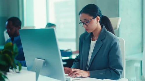 Focused Professional Working at a Modern Office Desk