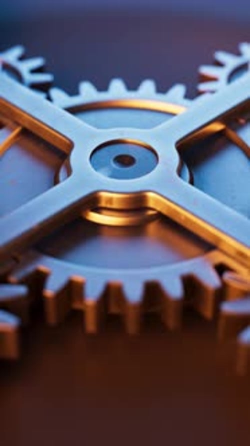 Loop-Animation einer mechanischen Struktur aus Metallzahnrädern.