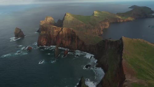 Aerial View of Rugged Coastline and Ocean Waves