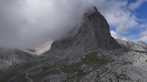 Clouds covering peak Picos de Europa Spain high in mountains drone, aerial