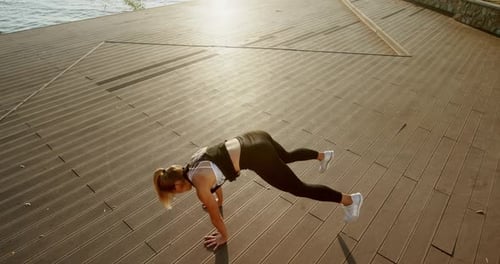 Female Athlete Training on Embankment