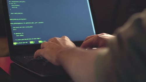 Close up hands developing software app using digital laptop computer typing and coding code on lapto
