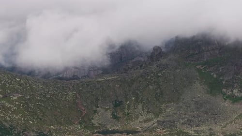 Mountain Range Under Misty Clouds From Above